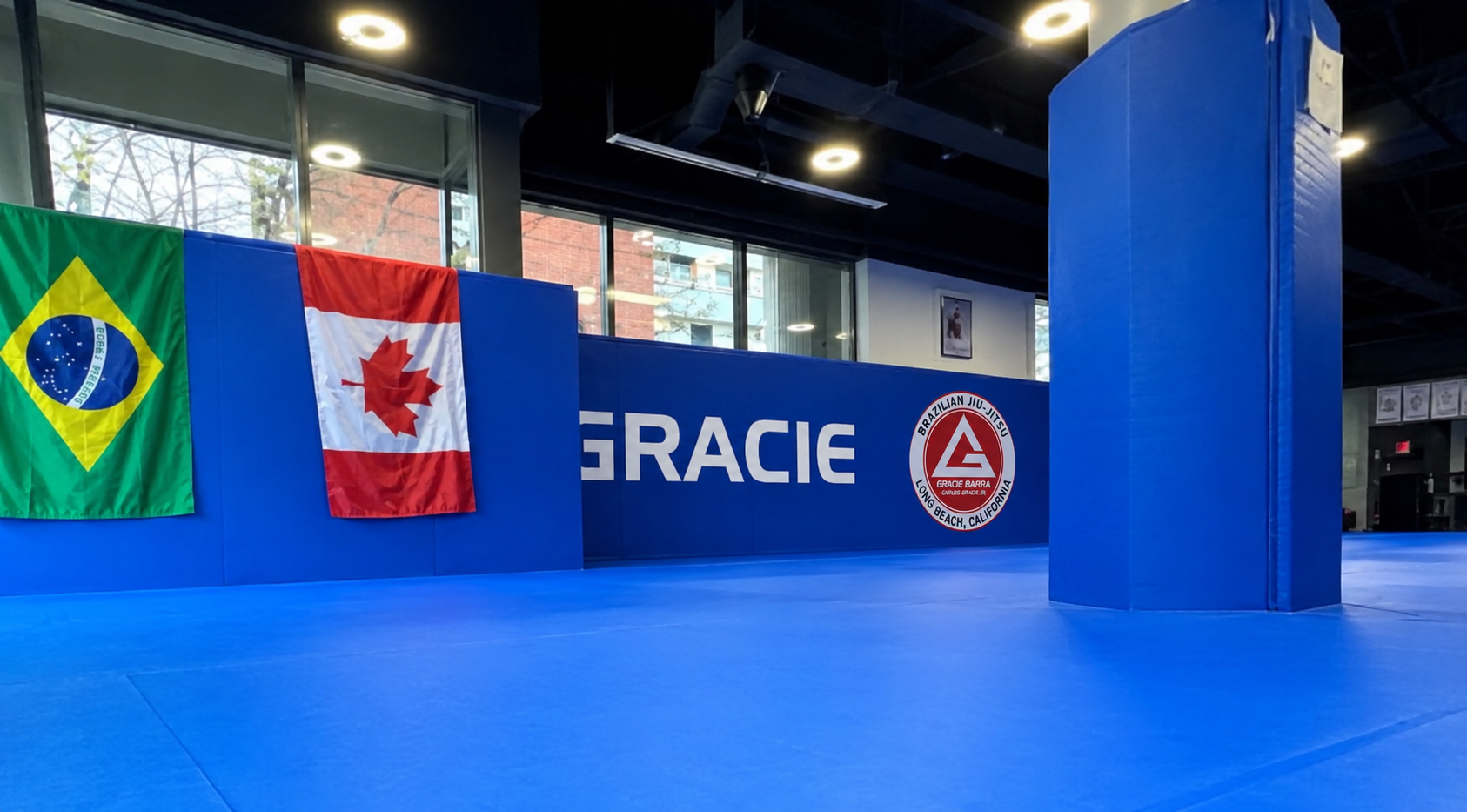 Gracie Barra Long Beach, CA - Jiu-Jitsu & Self-Defense 16 Blue mats with Brazilian and Canadian flags on the wall
