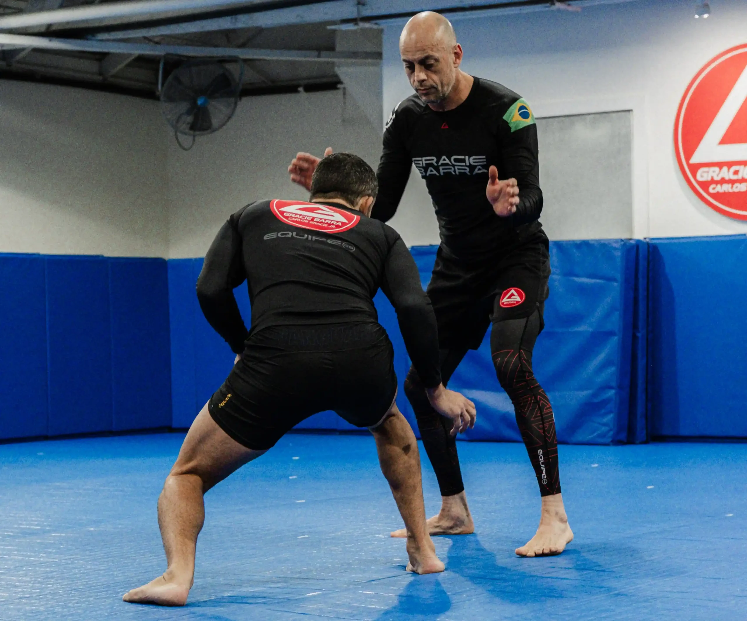 Gracie Barra Long Beach, CA - Jiu-Jitsu & Self-Defense 4 Two athletes in rash guards hand-fighting in No-Gi training