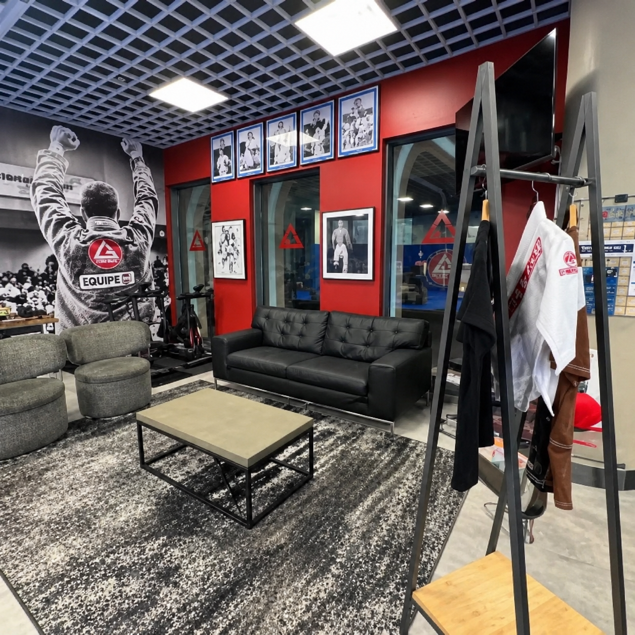 Gracie Barra Long Beach, CA - Jiu-Jitsu & Self-Defense 14 Academy lounge with leather sofa and framed photos