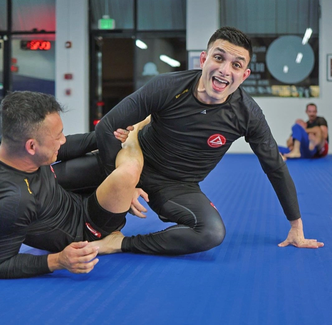 Gracie Barra Long Beach, CA - Jiu-Jitsu & Self-Defense 12 team in black-patch boy hugging on the mats