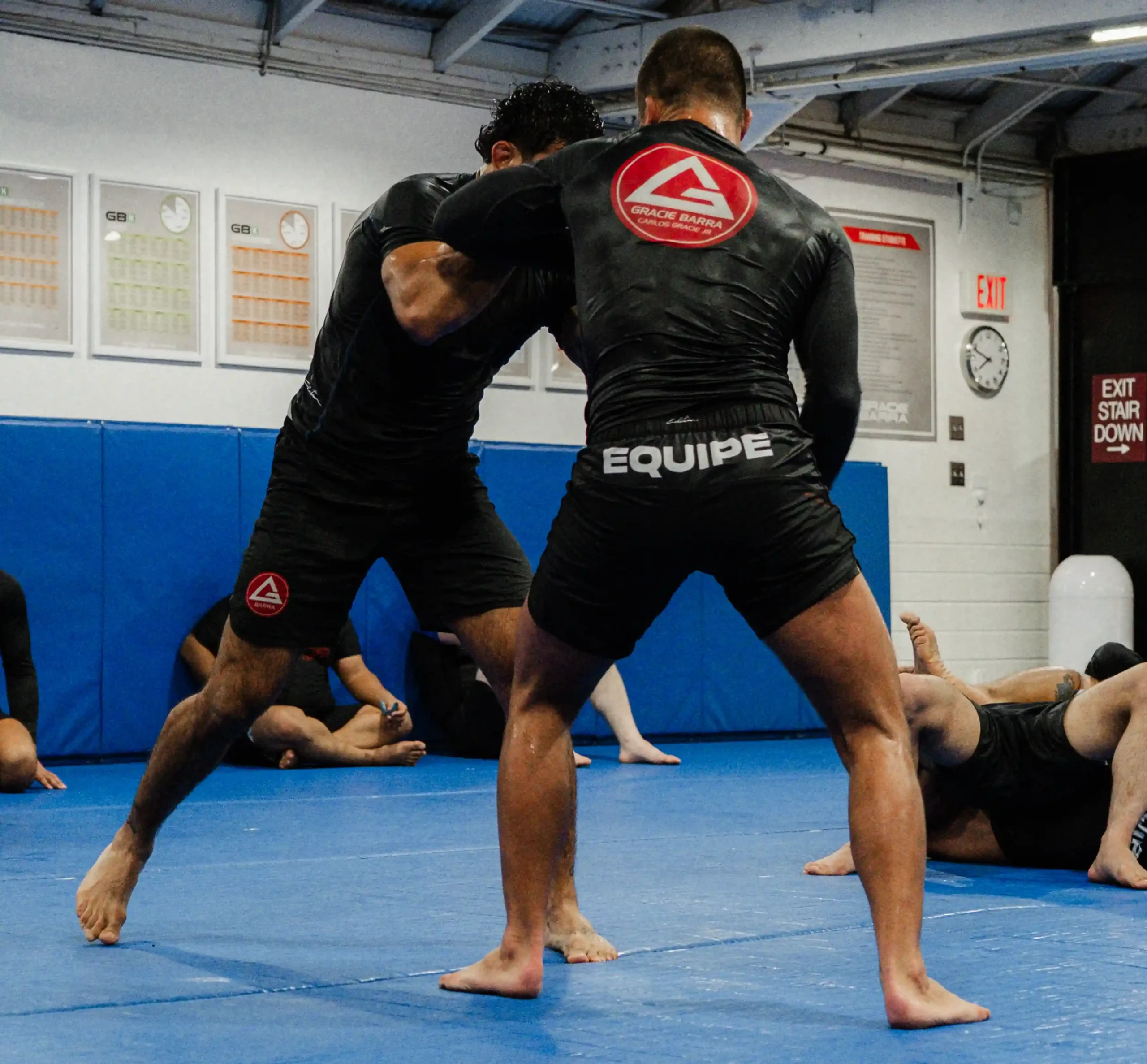 Two Gracie Barra Long Beach students practicing standing techniques in No-Gi training