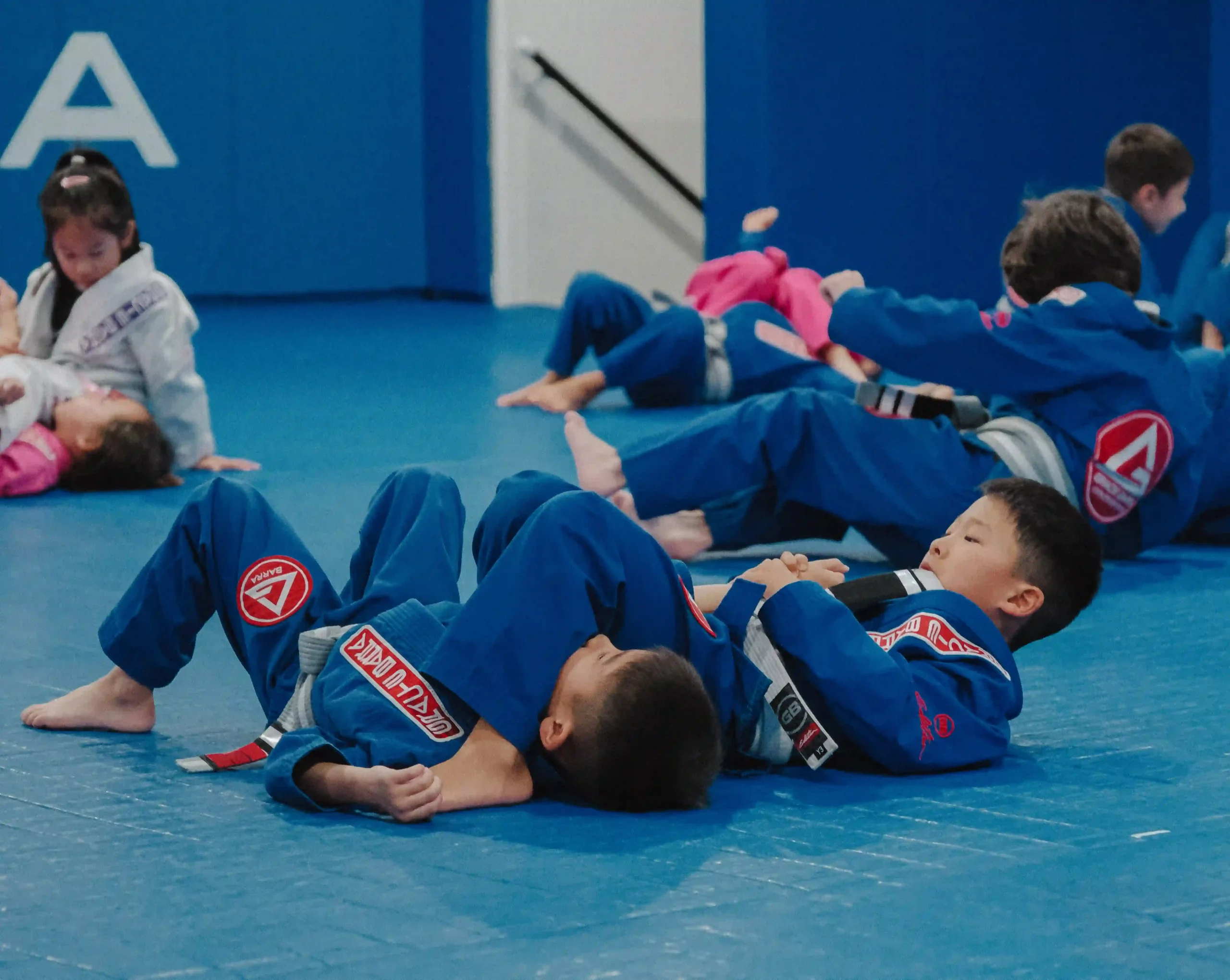 Children practicing Jiu-Jitsu on the mats at Gracie Barra Long Beach